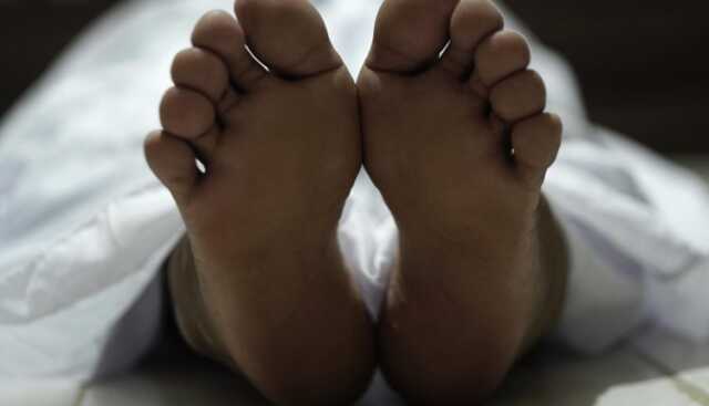 Dead Body Laying On A Floor Focus At The Foot Free Photo 750x430